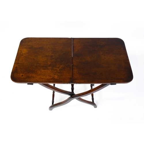 1467 - A Georgian mahogany coaching table raised on shaped legs with turned stretchers. 34