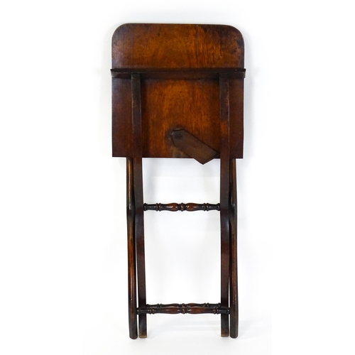 1467 - A Georgian mahogany coaching table raised on shaped legs with turned stretchers. 34