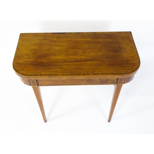 1468 - A late 18thC / early 19thC mahogany card table with satinwood crossbanded decoration, the table rais... 