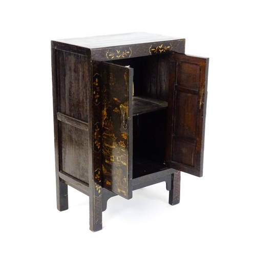 1469 - A late 19thC / early 20thC oriental cabinet with painted decoration depicting a village scene with p... 