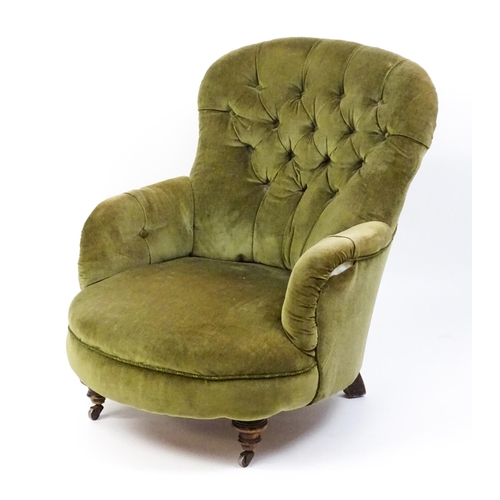 1474 - A late 19thC tub chair with a deep buttoned backrest above a sprung seat raised on turned tapering f... 