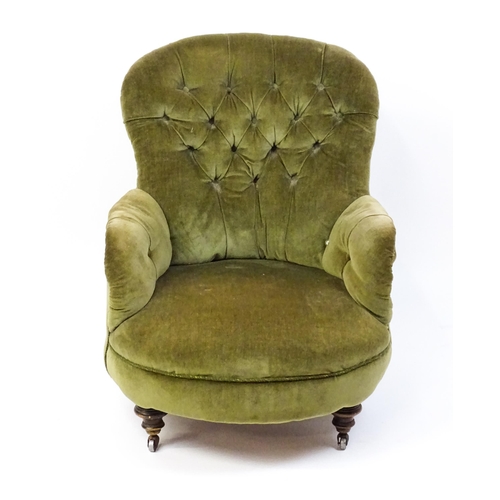 1474 - A late 19thC tub chair with a deep buttoned backrest above a sprung seat raised on turned tapering f... 