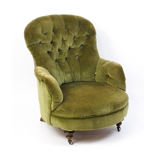 1474 - A late 19thC tub chair with a deep buttoned backrest above a sprung seat raised on turned tapering f... 