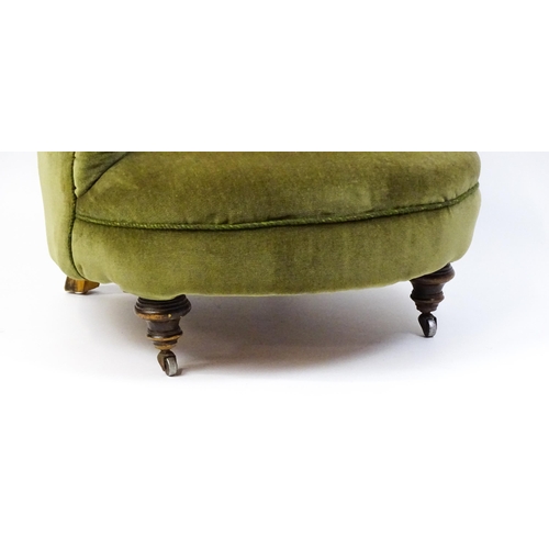 1474 - A late 19thC tub chair with a deep buttoned backrest above a sprung seat raised on turned tapering f... 