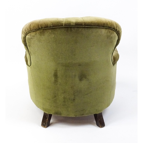 1474 - A late 19thC tub chair with a deep buttoned backrest above a sprung seat raised on turned tapering f... 