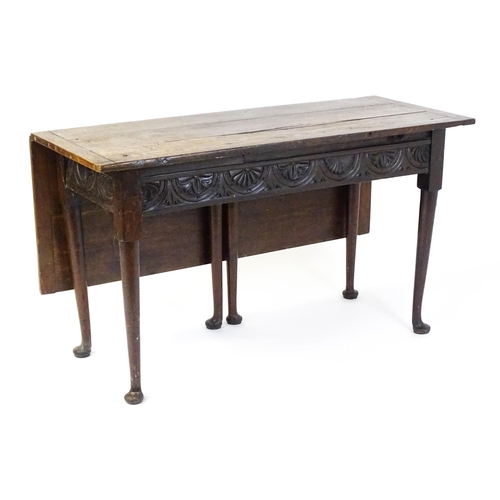 1493 - A Victorian oak gateleg table with nulled apron raised on six turned tapering legs terminating in pa... 