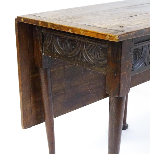 1493 - A Victorian oak gateleg table with nulled apron raised on six turned tapering legs terminating in pa... 