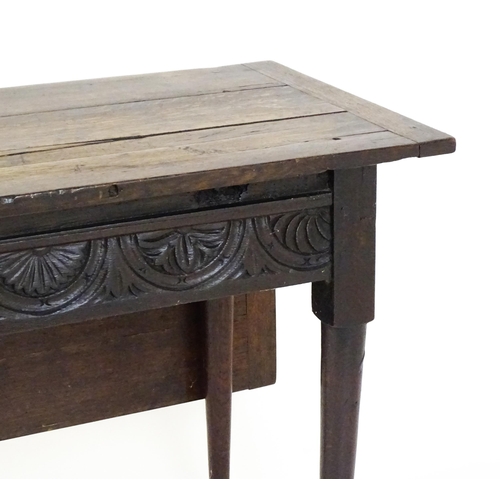 1493 - A Victorian oak gateleg table with nulled apron raised on six turned tapering legs terminating in pa... 