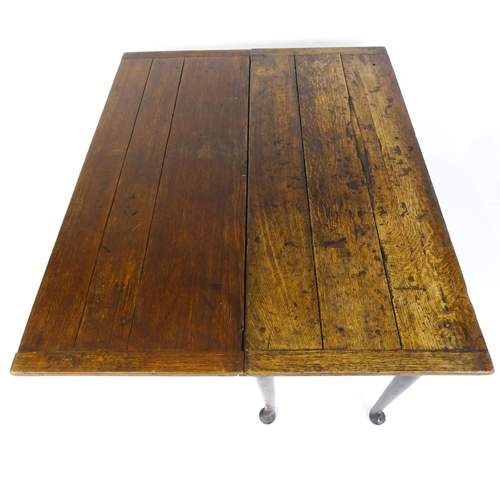 1493 - A Victorian oak gateleg table with nulled apron raised on six turned tapering legs terminating in pa... 