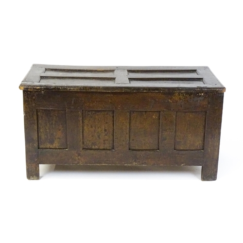 1602 - A late 17thC oak coffer with a triple panelled front with lozenge carved panels and rails raised on ... 