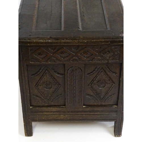 1602 - A late 17thC oak coffer with a triple panelled front with lozenge carved panels and rails raised on ... 