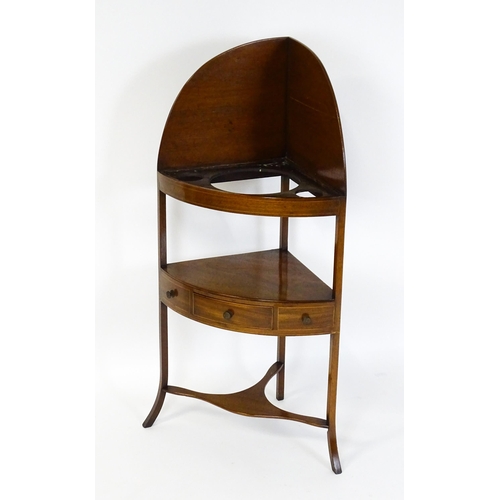 1604 - A late Georgian mahogany washstand with a removeable top. The stand having a large upstand above two... 