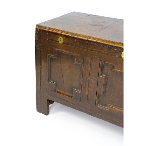 1626 - A late 17thC oak coffer with three geometrically moulded panels raised on stile feet. 48