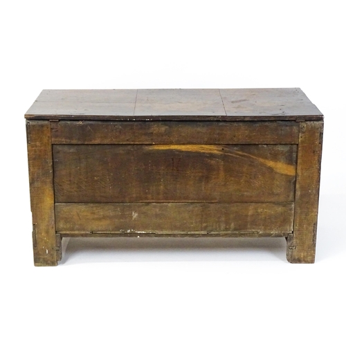 1626 - A late 17thC oak coffer with three geometrically moulded panels raised on stile feet. 48