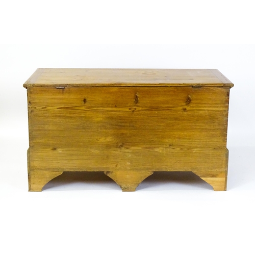 1627 - A 19thC pine mule chest with a hinged lid above two short drawers raised on shaped bracket feet and ... 