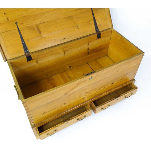 1627 - A 19thC pine mule chest with a hinged lid above two short drawers raised on shaped bracket feet and ... 