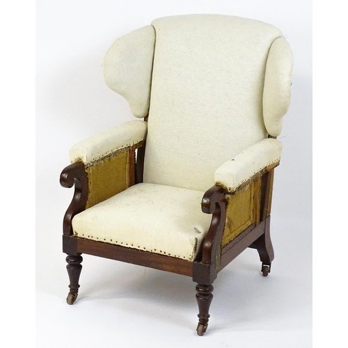 1555 - A Victorian mahogany reclining wingback armchair (John Ward patent) with scrolled arms and raised on... 