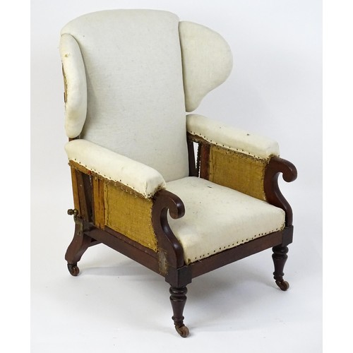 1555 - A Victorian mahogany reclining wingback armchair (John Ward patent) with scrolled arms and raised on... 