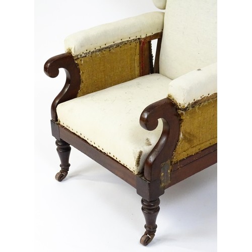 1555 - A Victorian mahogany reclining wingback armchair (John Ward patent) with scrolled arms and raised on... 