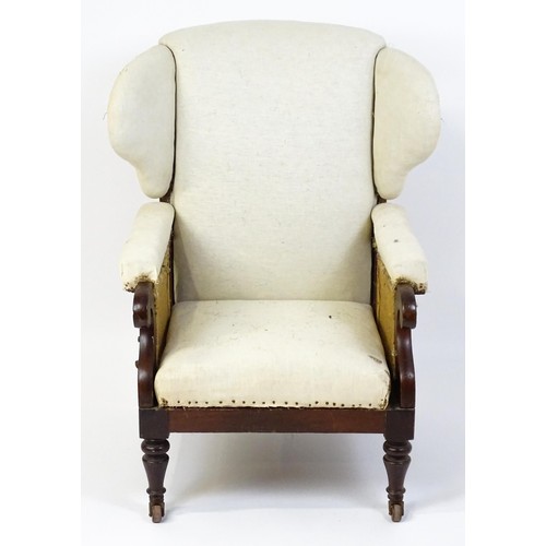 1555 - A Victorian mahogany reclining wingback armchair (John Ward patent) with scrolled arms and raised on... 