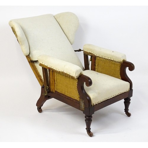 1555 - A Victorian mahogany reclining wingback armchair (John Ward patent) with scrolled arms and raised on... 