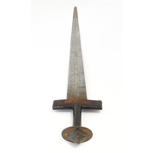 835 - Militaria : an early 20thC North African Tuareg takoba sword and scabbard , the leather covered hilt... 