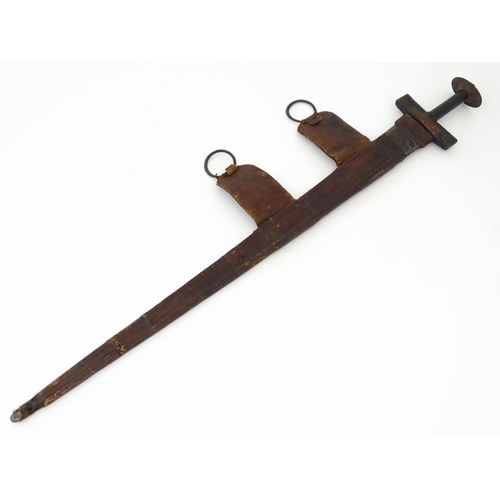 835 - Militaria : an early 20thC North African Tuareg takoba sword and scabbard , the leather covered hilt... 