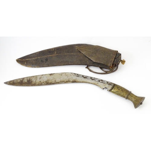 846 - An early to mid 20thC Kukri / Khukuri knife and leather sheath , the brass sectional hilt and steel ... 