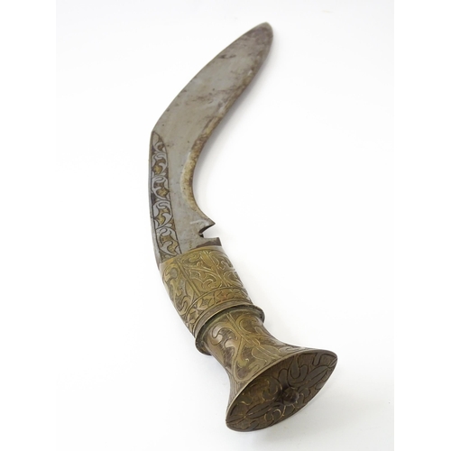 846 - An early to mid 20thC Kukri / Khukuri knife and leather sheath , the brass sectional hilt and steel ... 