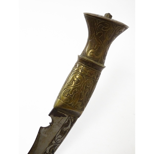 846 - An early to mid 20thC Kukri / Khukuri knife and leather sheath , the brass sectional hilt and steel ... 