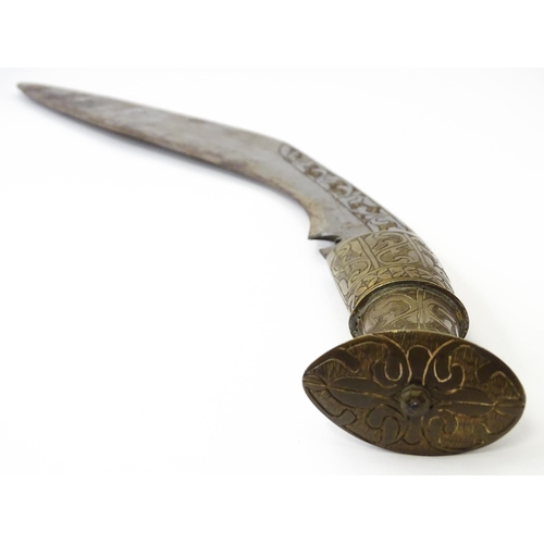 846 - An early to mid 20thC Kukri / Khukuri knife and leather sheath , the brass sectional hilt and steel ... 