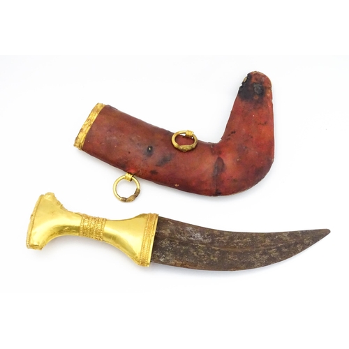 849 - An early 20thC Yemeni Jambiya dagger and sheath, the steel blade with yellow metal hilt decorated wi... 