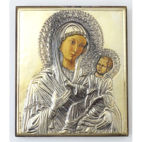 1056 - A 19thC Italian icon depicting Madonna and Child with an embossed silver surround. Marked lower left... 