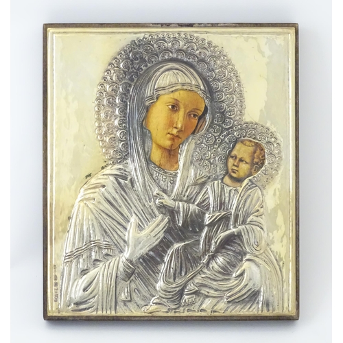 1056 - A 19thC Italian icon depicting Madonna and Child with an embossed silver surround. Marked lower left... 