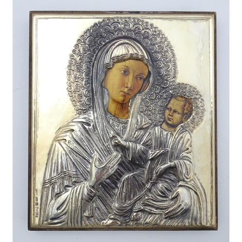 1056 - A 19thC Italian icon depicting Madonna and Child with an embossed silver surround. Marked lower left... 