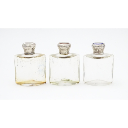 500A - A set three glass scent / perfume flasks of shaped form with silver tops with red, white and blue en... 