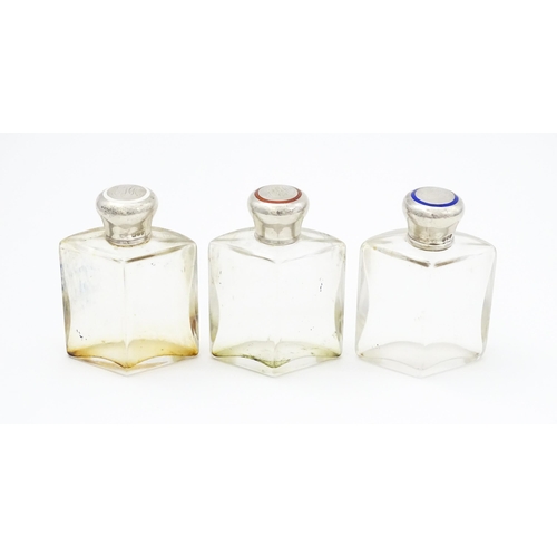 500A - A set three glass scent / perfume flasks of shaped form with silver tops with red, white and blue en... 