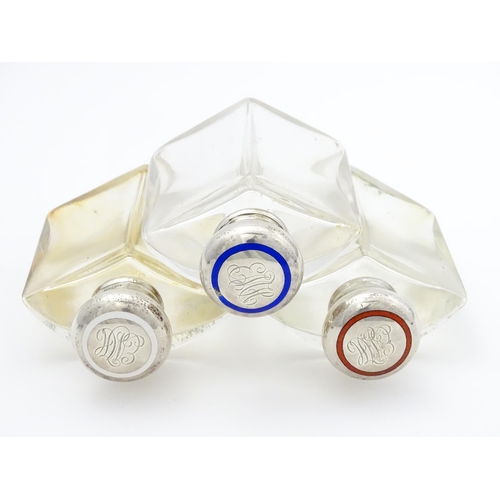 500A - A set three glass scent / perfume flasks of shaped form with silver tops with red, white and blue en... 