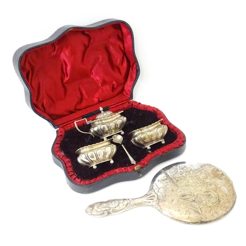 561A - A cased Victorian three piece silver cruet set comprising salt, pepper and mustard, together with an... 