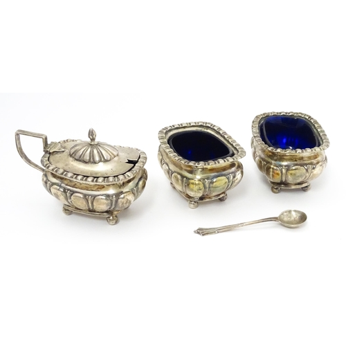 561A - A cased Victorian three piece silver cruet set comprising salt, pepper and mustard, together with an... 