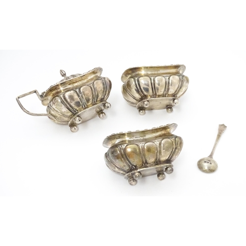 561A - A cased Victorian three piece silver cruet set comprising salt, pepper and mustard, together with an... 