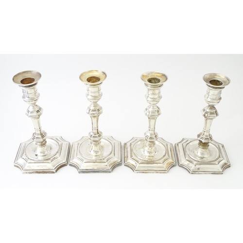 595 - A matched set of four silver candlesticks  hallmarked Sheffield 1894 and 1907, maker Hawksworth, Eyr... 