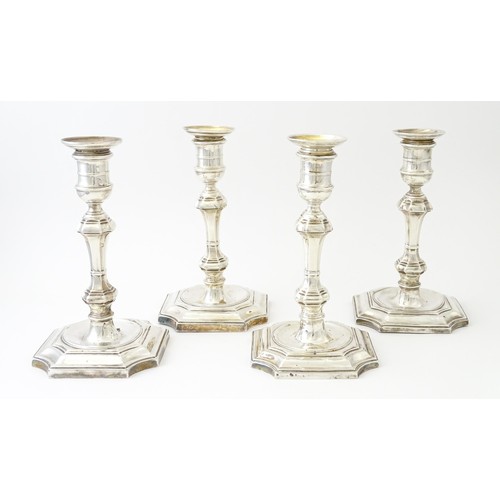 595 - A matched set of four silver candlesticks  hallmarked Sheffield 1894 and 1907, maker Hawksworth, Eyr... 