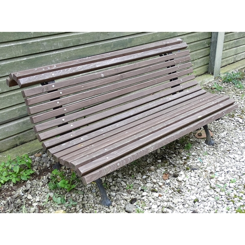 1335 - An early 20thC tennis bench , with Coalbrookdale style cast iron frame and hardwood slats , approx 6... 