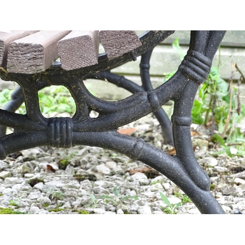 1335 - An early 20thC tennis bench , with Coalbrookdale style cast iron frame and hardwood slats , approx 6... 