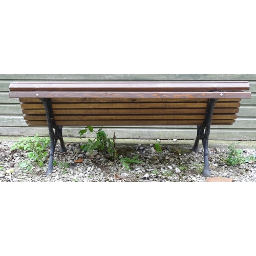 1335 - An early 20thC tennis bench , with Coalbrookdale style cast iron frame and hardwood slats , approx 6... 