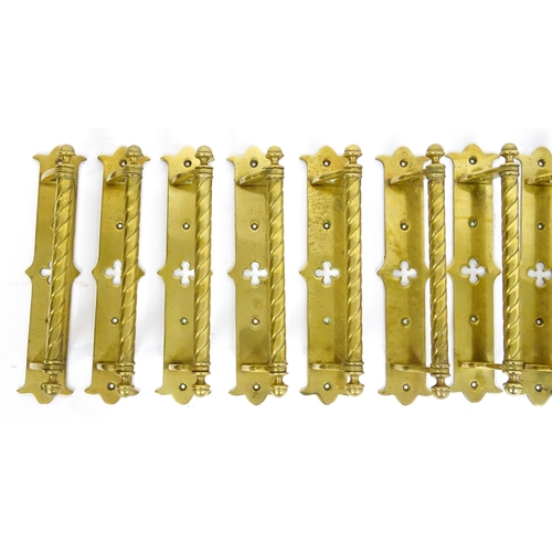 1348 - A quantity of cast brass Gothic revival door handles, the mounts with pierced quatrefoil decoration ... 