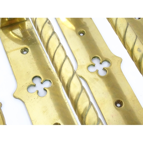 1348 - A quantity of cast brass Gothic revival door handles, the mounts with pierced quatrefoil decoration ... 