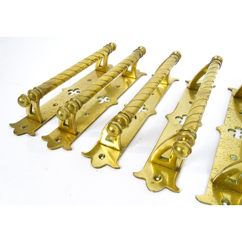 1348 - A quantity of cast brass Gothic revival door handles, the mounts with pierced quatrefoil decoration ... 