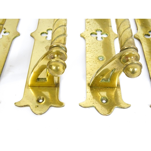 1348 - A quantity of cast brass Gothic revival door handles, the mounts with pierced quatrefoil decoration ... 